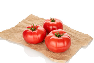 Three pink tomatoes in a paper bag, close-up, isolated on a white background.