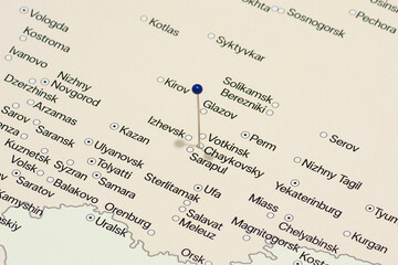 Fototapeta premium macro photo of a blue pin needle into chaykovsky city of Russia political map