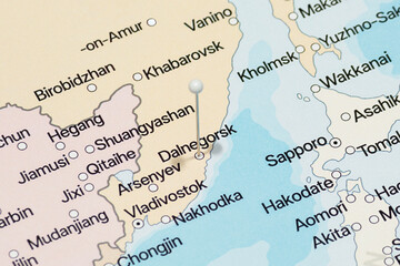 macro photo of a white pin needle into Dalnegorsk city of Russia political map