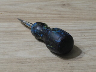 black screwdriver on wood background