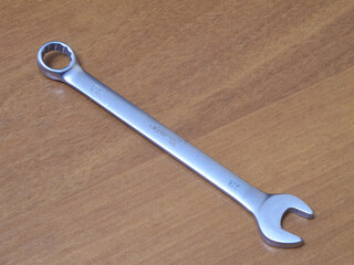 metal wrench on wood background
