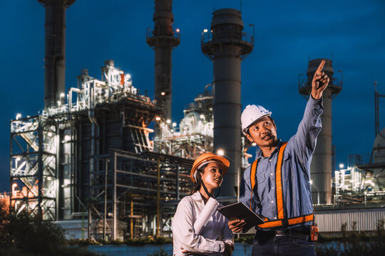 Engineer worker team night working against petroleum gas turbine power plant, Night shift survey inspector outdoor