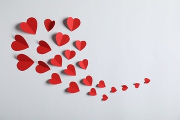 Many paper hearts on light grey background, flat lay