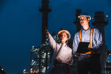 Engineer worker team night working against petroleum gas turbine power plant, Night shift survey...