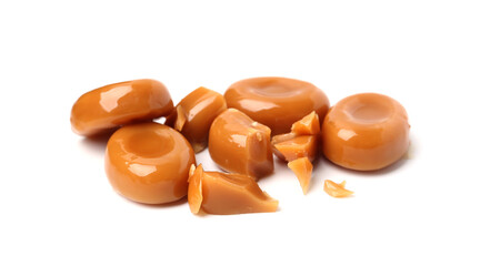 Tasty sweet caramel candies isolated on white