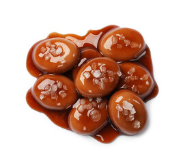 Tasty sweet candies, salt and caramel sauce isolated on white, top view