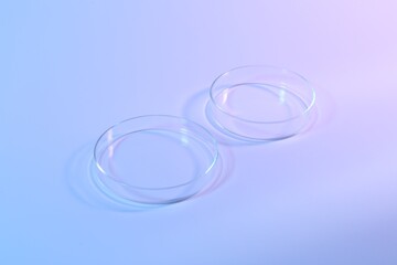 Two empty Petri dishes on light background