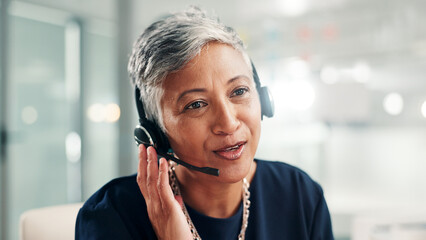 Mature, happy woman or consultant talking with headset at call center for online communication. Female person, agent or employee with mic or technology for virtual assistance or customer service