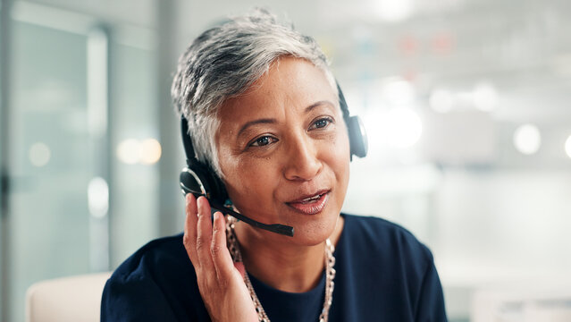 Mature, happy woman or consultant talking with headset at call center for online communication. Female person, agent or employee with mic or technology for virtual assistance or customer service