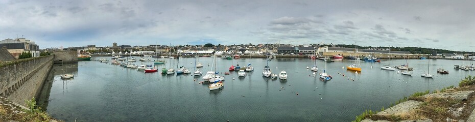 Fototapeta premium Panoramic view of a harbor with moored boats on a cloudy day