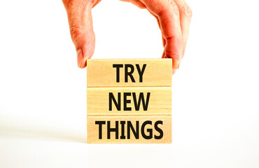 Try new things symbol. Concept words Try new things on beautiful wooden block. Businessman's hand....