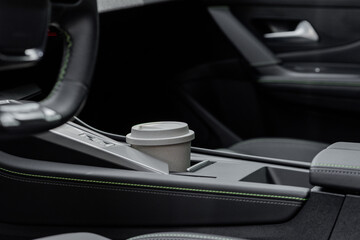 Modern car interior with coffee cup in the cup holder