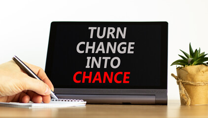 Turn change into chance symbol. Concept words phrase Turn change into chance on beautiful tablet....