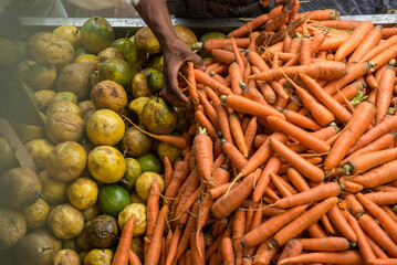 View of many carrots gathered on a counter ready for sale. Healthy food.