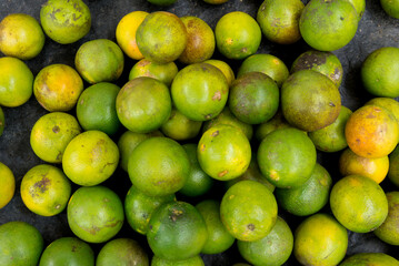 Yellow oranges gathered on a counter ready for sale. Citrus fruit.