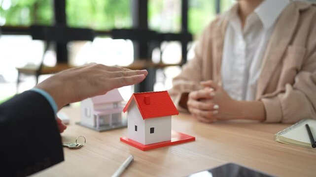 Asian woman discussing housing project with real estate agent