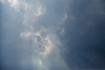 Sky with dark clouds and sun rays