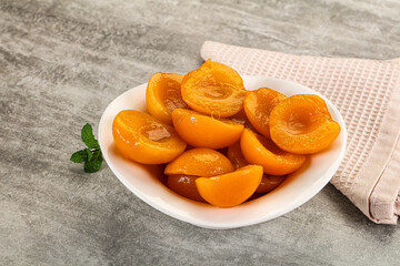Sweet canned apricots with syrope