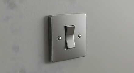 A close up shot of a silver light switch mounted on a gray wall in a well lit room