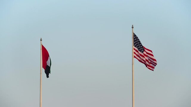 USA and UAE flags are blown in the wind