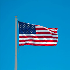 Fototapeta premium American Flag: Waving in Blue Sky