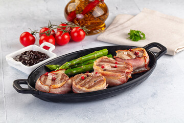Tasty grilled pork medallion with bacon