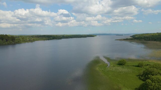 Low drone shot of blue Irish lake on sunny day. Lough Melvin, Co. Leitrim, Ireland.