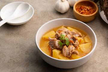 Pork Baby Back Ribs or pork cartilage clear soup with pineapple fruit in white bowl.sweet and sour test,asian food.