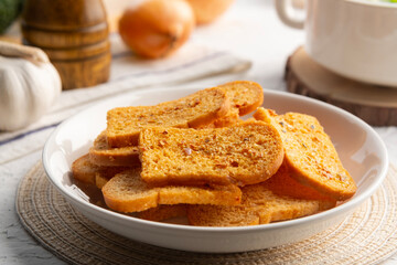 Close up Thai crispy garlic bread on white plate.Bread with butter and garlic.Thai snack food.