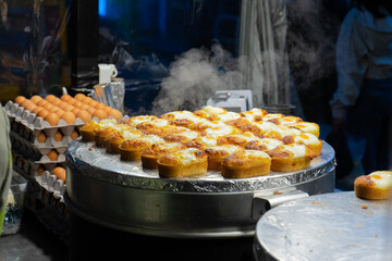 Freshly Cooked Korean Egg Bread Steaming on a Griddle, Seoul, South Korea, Myeongdong Market, Night Street Food Scene