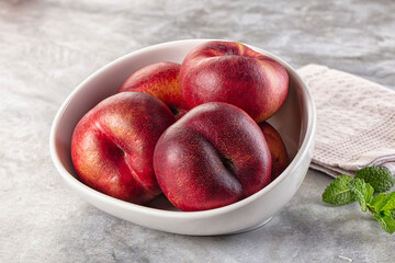 Ripe sweet juicy flat nectarines heap