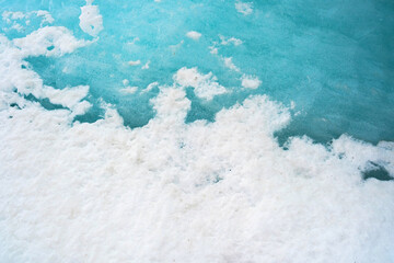 Macro view of icy blue glacier and white snow textures in chamonix
