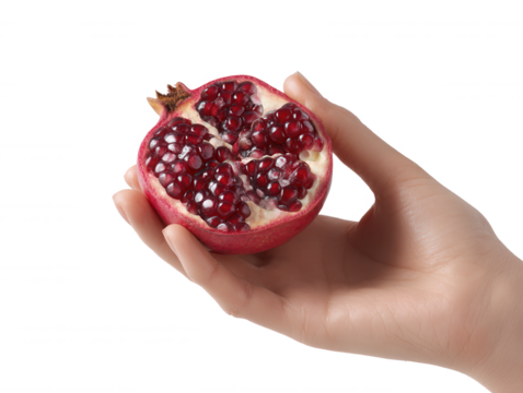 A hand gently holds a vibrant half pomegranate revealing its juicy ruby red seeds against a clean white background highlighting freshness and natural goodness.