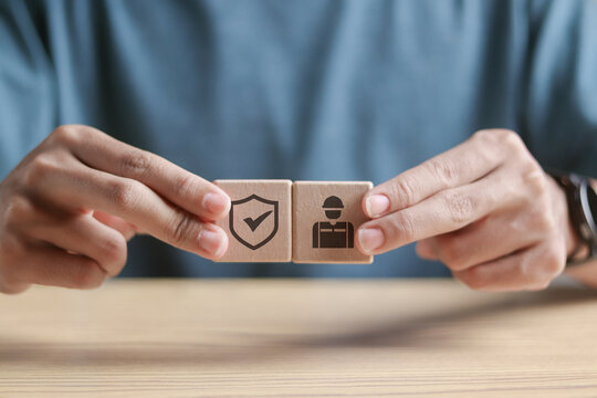Work safety concept. Regulations and standard in industry. Working standard process and zero accidents. Person holding wooden block with work safety icon.