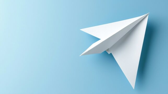 A white paper airplane against a light blue background.