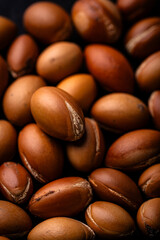 Pile of brown argan nuts texture
