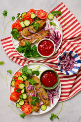 Chicken Lula Kebab with fresh vegetables and hot sauce on a platter.top veiw