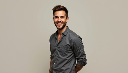 Fototapeta premium Handsome Young Man Smiling in Casual Gray Shirt Against Neutral Background