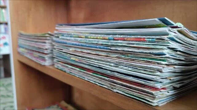 Closeup view 4k video footage of old paper texture of many old stacked magazines. A stack of old magazines.