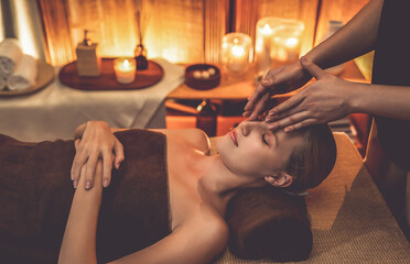 Caucasian woman enjoying relaxing anti-stress head massage and pampering facial beauty skin...