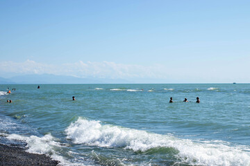 A group of people are swimming in the ocean