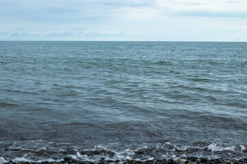 The ocean is calm and the sky is cloudy