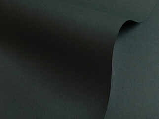 Dark green matte paper texture with a premium, sleek finish, featuring wavy folds and edges. Elegant