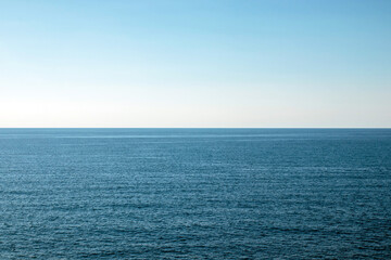 The ocean is calm and clear, with no visible waves or ripples