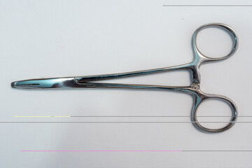 Isolated Surgical Forceps or clamp on white backgorund. Medical instrument