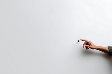 A hand pointing at a single coffee bean on a minimalist white background, suggesting focus and precision.