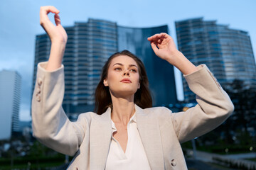 Confident businesswoman posing outdoors in modern cityscape, showcasing elegance and determination...
