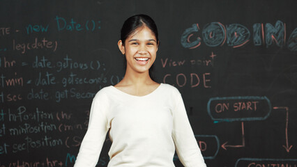 Young student celebrate her successful plan while raise her arm. Happy teenager looking at camera...