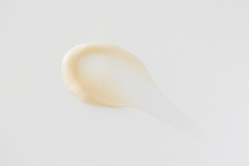 Minimalist beige smear cream on white background
