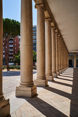 Elegant architectural columns with shadow play in a european city's arcade